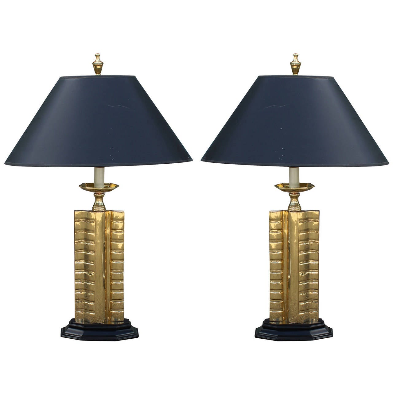 Great heavy pair of shiny Gold and brass table lamps. Lamps sit on black bases and which tie in with the matching black shades.