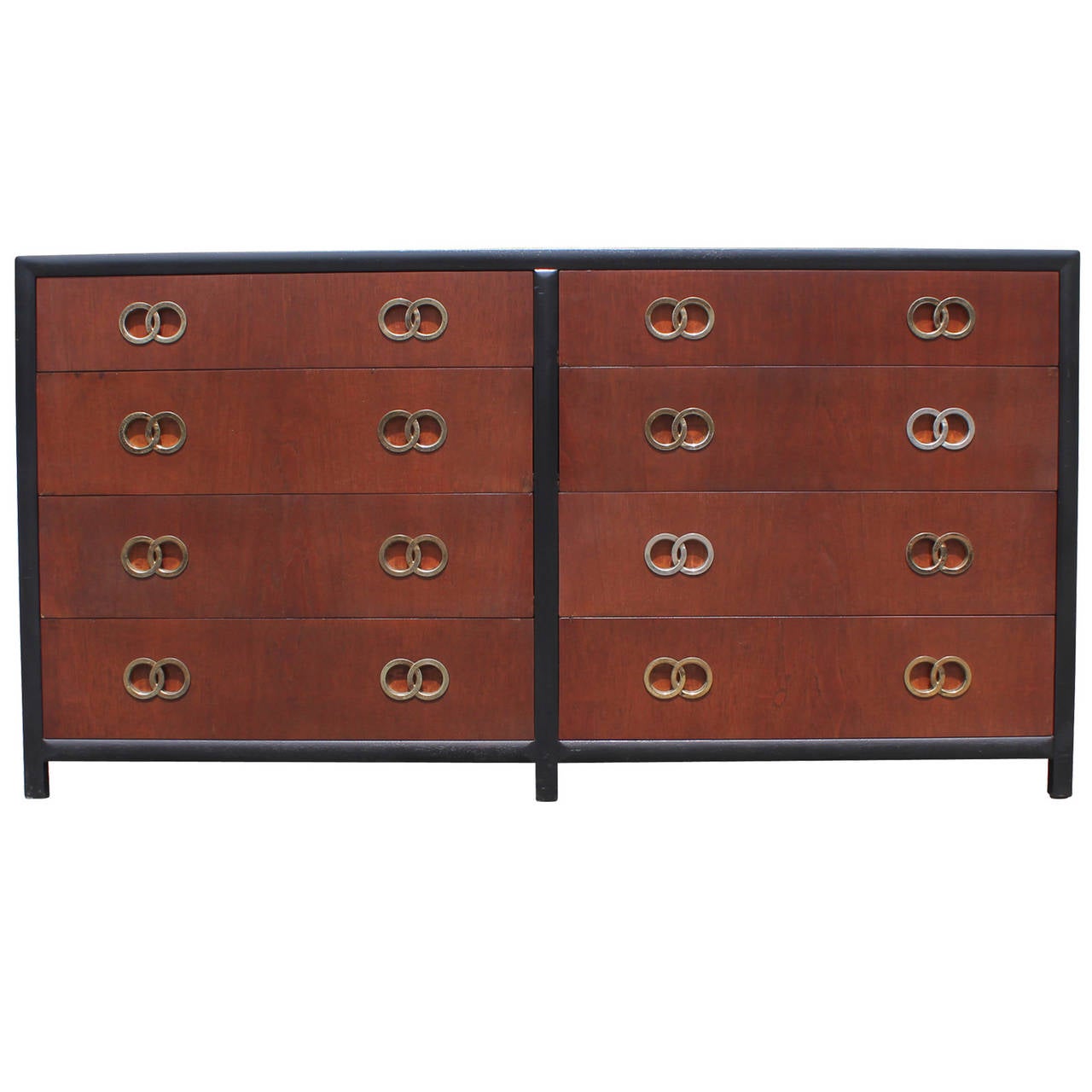 Glamorous eight-drawer dresser designed by Michael Taylor for Baker. Finished in walnut and ebony. Dresser has incredible interlocking ring pulls. Brass has a nice aged patina - handles can also be polished into chrome.