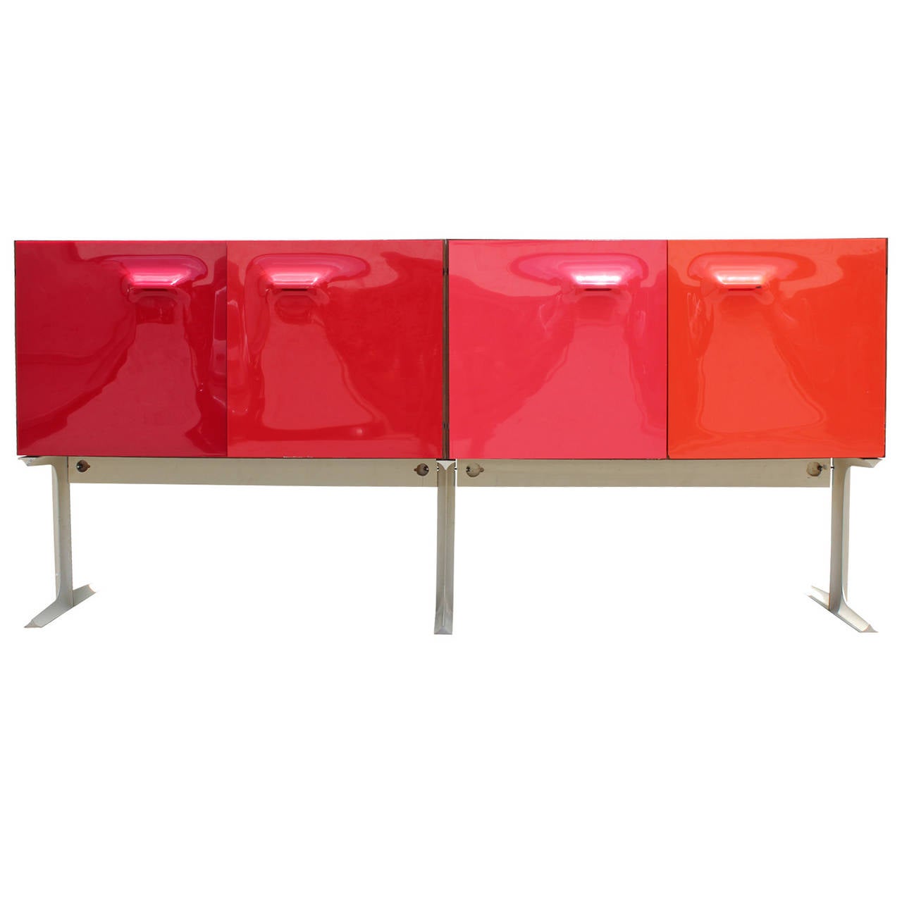 Rare double sided cabinet or sideboard by Raymond Loewy. Four bold colored plastic doors line either side of the piece. Doors range in color from red to pink to orange and open to reveal lemon yellow shelves and a white drink caddy.  Metal base is