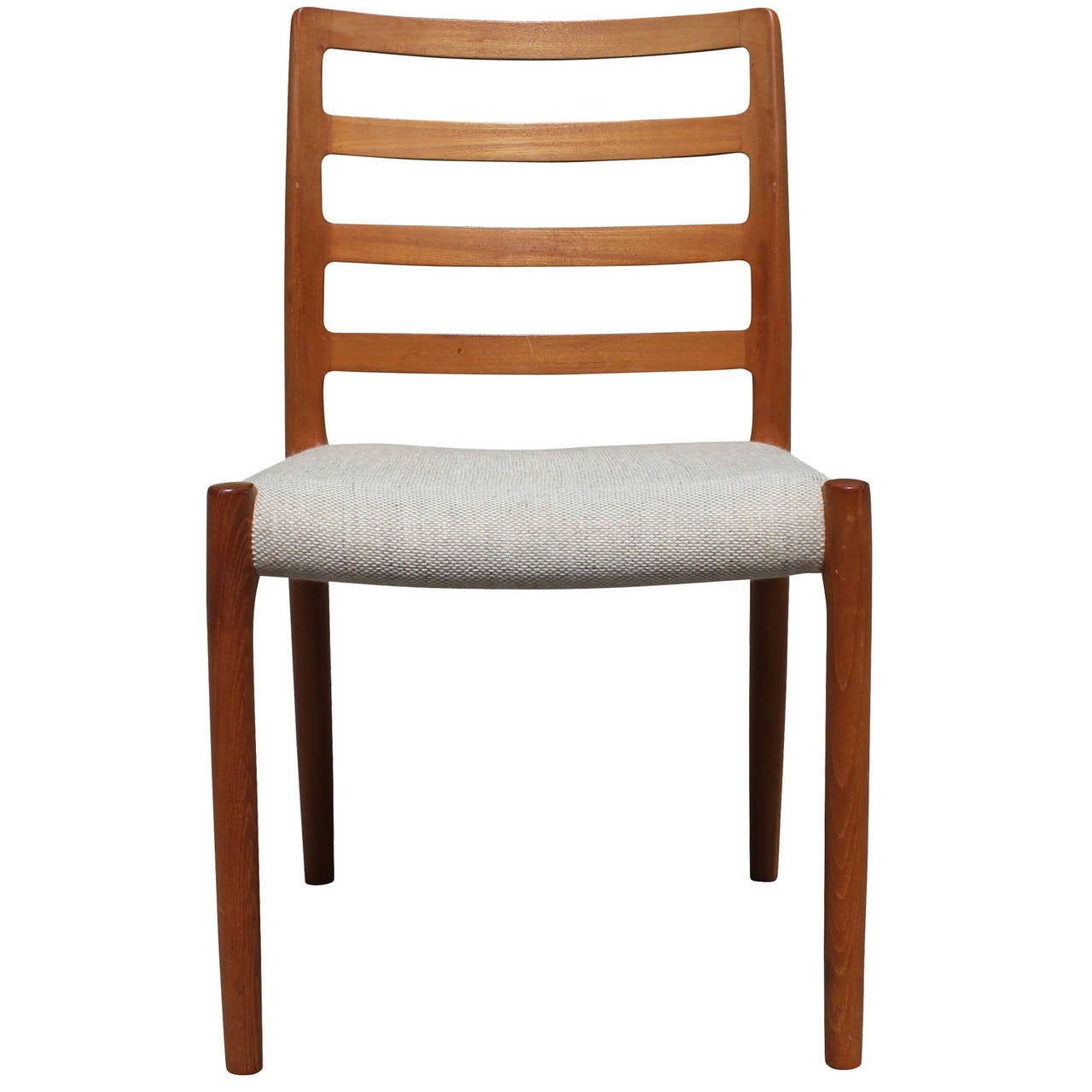 Great set of four Danish ladder back JL Moller Model #85 Dining Chairs. Teak chairs are upholstered in a neutral fabric which could use re-upholstery. Lovely set with soft curved edges.