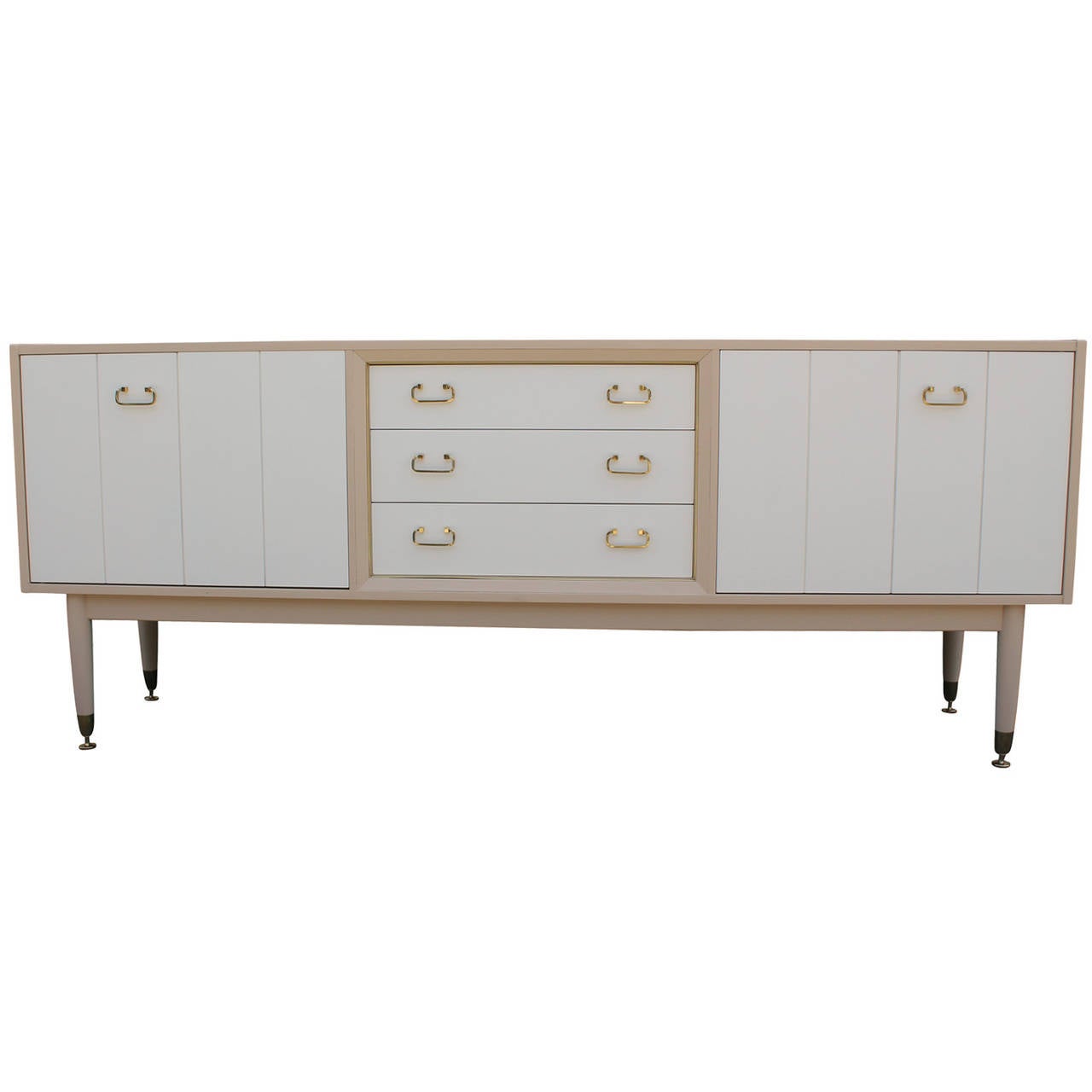 Stunning khaki and cream lacquered sideboard or credenza with brass handles and folding doors. Sideboard is restored superbly. Adjustable brass feet have been polished along with all hinges. Excellent piece of furniture.