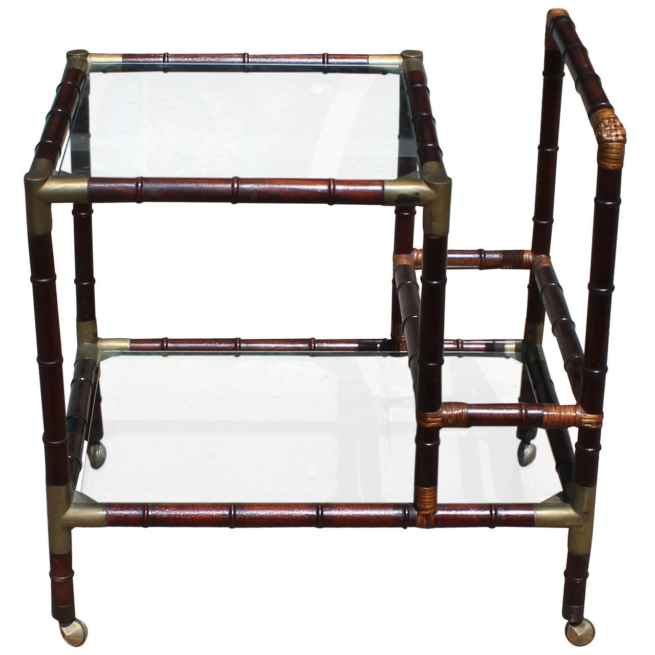 Charming faux bamboo bar cart. Cart has two glass shelves and brass hardware. In excellent vintage condition.