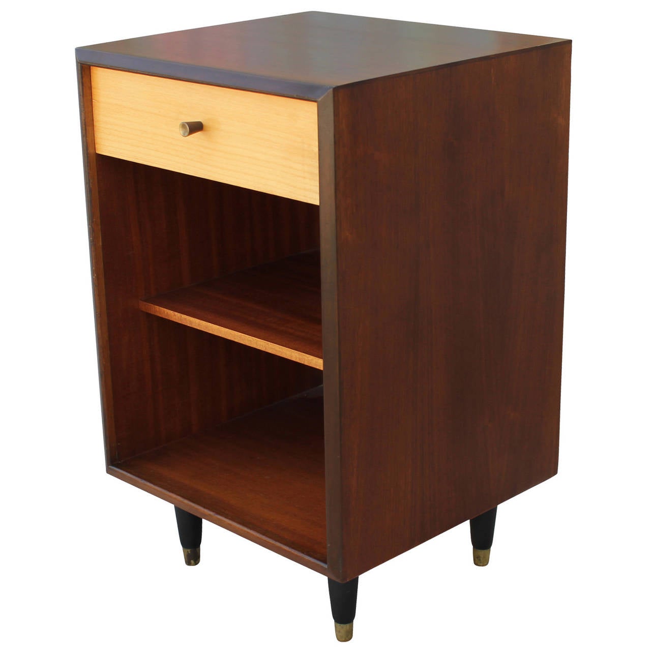 Beautiful pair of night stands by White & Newton. Nightstands have a single drawer and a large open cabinet. Drawer is in a blonde wood, contrasting the walnut shell. Black tapered legs are capped in brass.