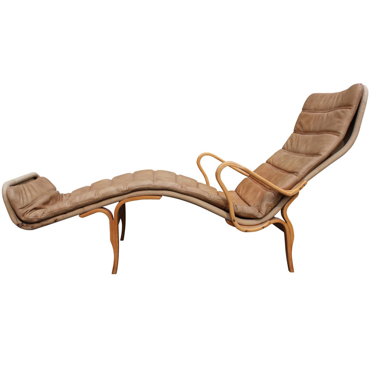 Sculptural chaise lounge by Bruno Mathsson for Dux. Chair is upholstered in original canvas with a neutral leather cushion. Frame is beautiful bentwood. Very comfortable and a fantastic statement piece. There is some slight discoloration of the