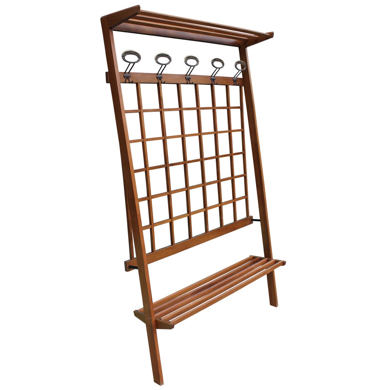 Incredible Italian hall tree. Decorative lattice work makes up the back portion. Five brass hooks provide jacket storage. A shoe rack and top rack provide additional storage. Hall tree fixes to wall. Would work great for a mud room.