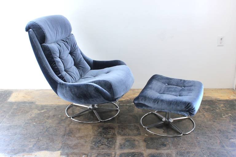 Incredible reupholstered space age lounge chair and ottoman with chrome base. The chair swivels and the fabric is very plush and soft. Probably Danish circa 1970. You will melt into this one!