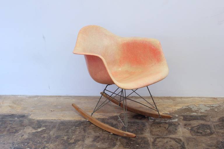 Extremely rare original roped edge Eames rocking chair with a very early base. Made by the Zenith plastics corporation in a pink salmon color. Chair shows fading and general wear, but is in great vintage condition. Remnants of the original label are