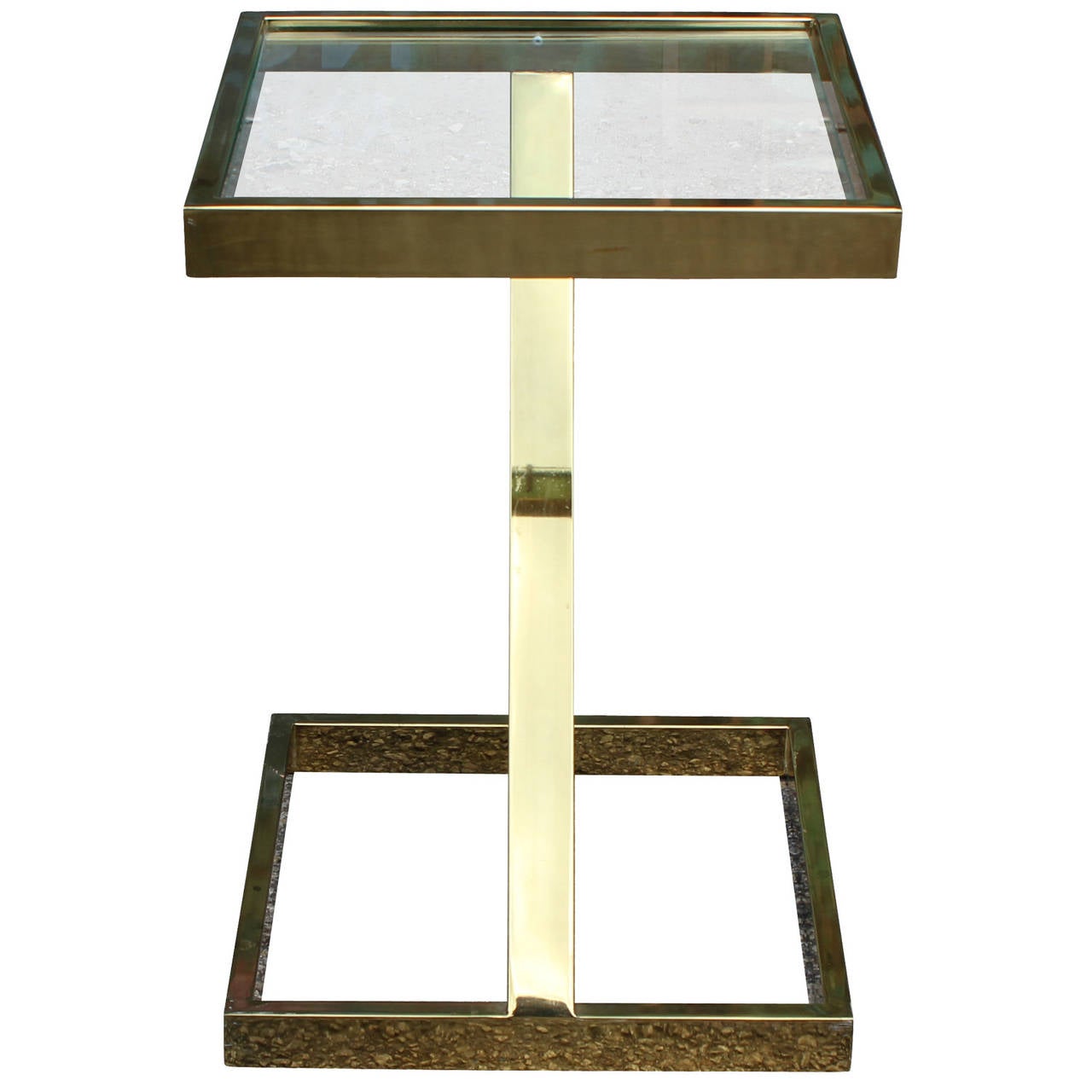 Great side table in the style of Milo Baughman for Design Institute America. Table is constructed of shiny brass with a single glass top. Angular piece is sure to add an architectural touch to any space.