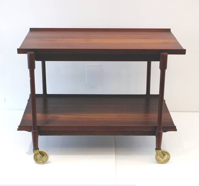 Poul Hundevad designed teak cart made is Denmark.  Excellent as a beverage cart with modular shelves, Top opens to accommodate two shelves side by side, doubling as a functional server.