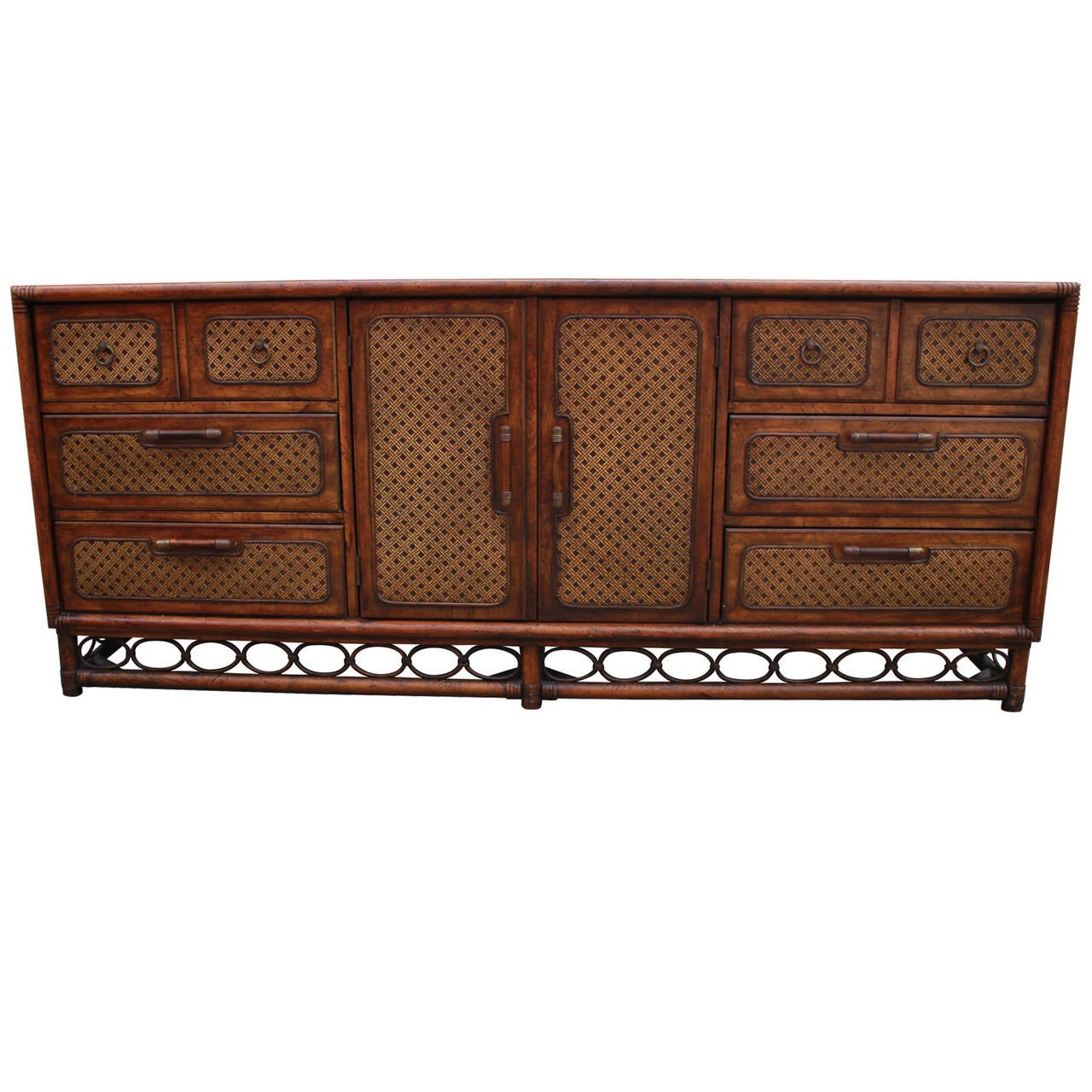 Wonderful dresser by American of Martinsville. Dresser has extraordinary detailing with a faux bamboo motif and cane front drawers. Aged brass hardware. Three drawers on either side provide excellent storage, while the two doors open to reveal three