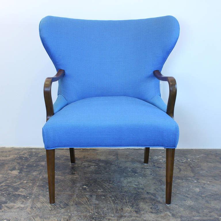 Curvy blue restored wingback armchair with walnut arms and legs. Beautiful from all angles. Perfect accent chair.