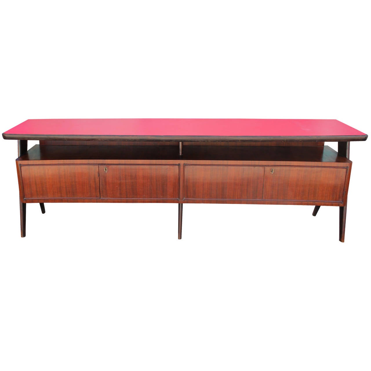 Sculptural Italian sideboard attributed to Vittorio Dassi. Sideboard is topped with a red laminate shelf. Four lockable doors open to cabinet space. Tapered angular full length side legs and short centre legs. Incredible quality and design. The legs