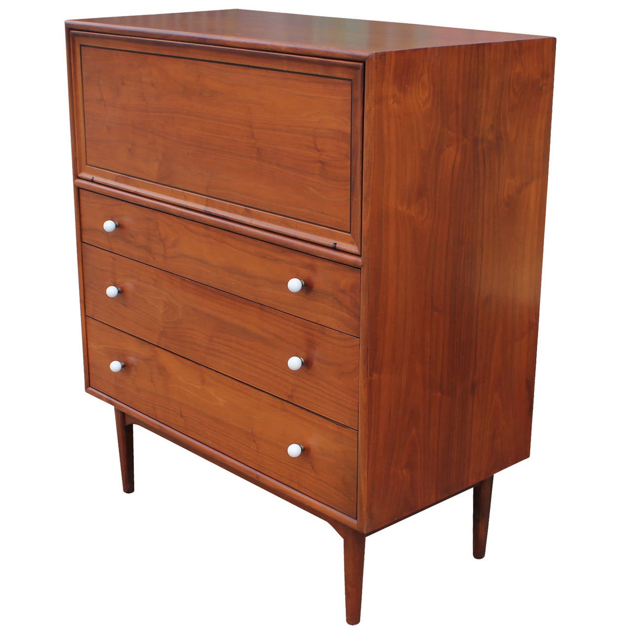 Beautiful Kipp Stewart for Drexel figured walnut dresser with white porcelain knobs. The dresser was made in 1961 and is the Declaration line. It is in excellent restored condition.