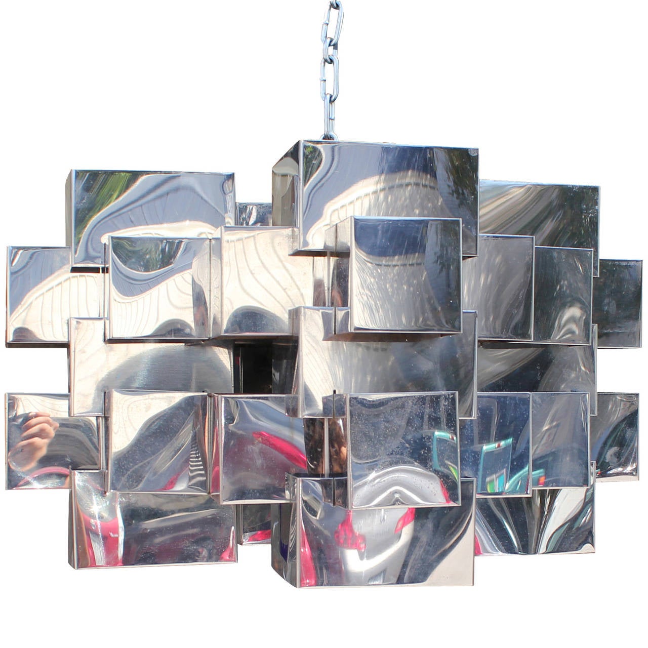 Incredible Brutalist or mid-century modern chandelier. Chandelier hangs from an industrial chain. Chrome Cubes create visual interest and dramatic shadows. Lit with four bulbs. Slight remains of signature is available.