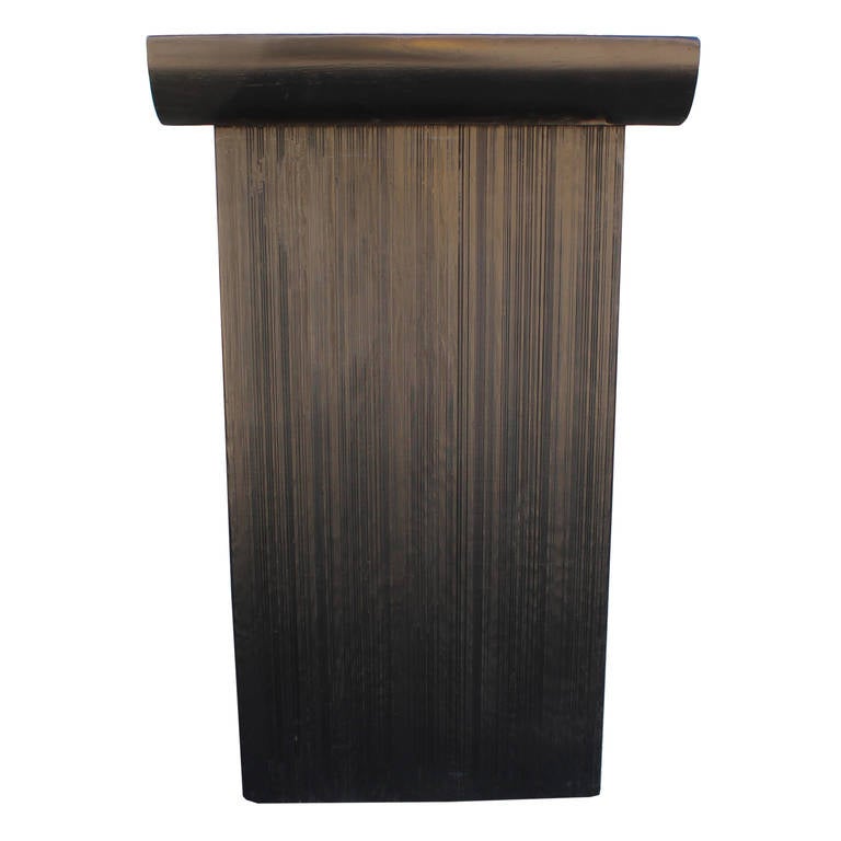 This dramatic console was designed by Paul Frankl for Johnson Furniture Company in the 1940s. The smooth, curved top is contrasted by the fluted textured legs. The table has been refinished in ebony.