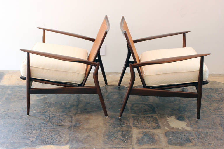 Sleek Pair of IB Kofod - Larsen for Selig Spear Arm chairs #544-15. Chairs are in excellent vintage condition. Fabric is vintage and could use updating. Back cushions are also available. Gorgeous chairs.