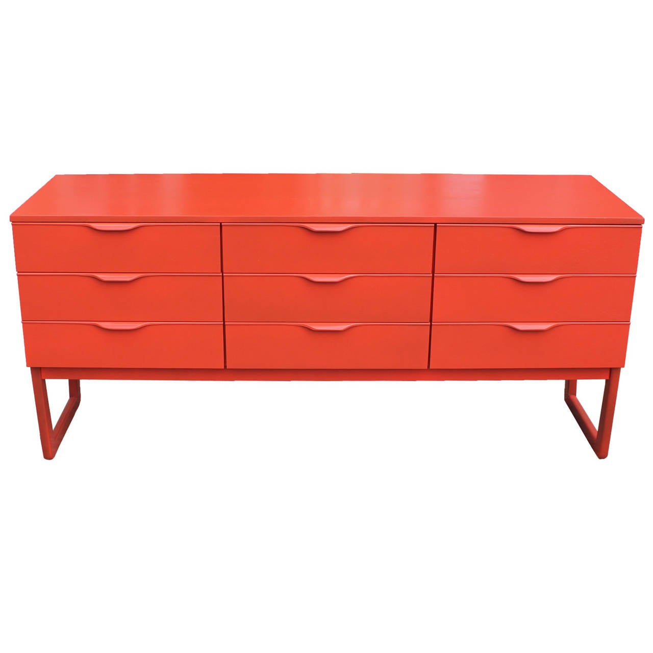 Beautiful dresser has been recently refinished in tangerine orange lacquer. Nine pull out drawers provide ample storage. Slightly tapered legs add visual interest.