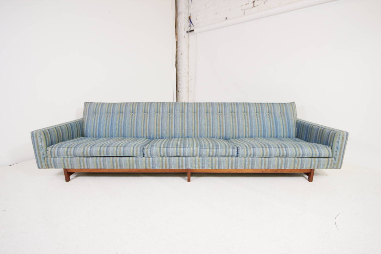 10 foot George Nelson style sofa floating on solid walnut frame base, we also have the matching 6 foot sofa to make a gorgeous sectional sofa or sofa set. Original condition so it could use upholstery.