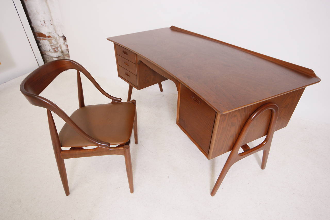 Absolutely stunning Danish modern sculpted desk with the most amazing walnut grain I have ever seen, comes with the original chair. Desk and chair newly refinished to better than original condition! Ten out of a ten desk!!