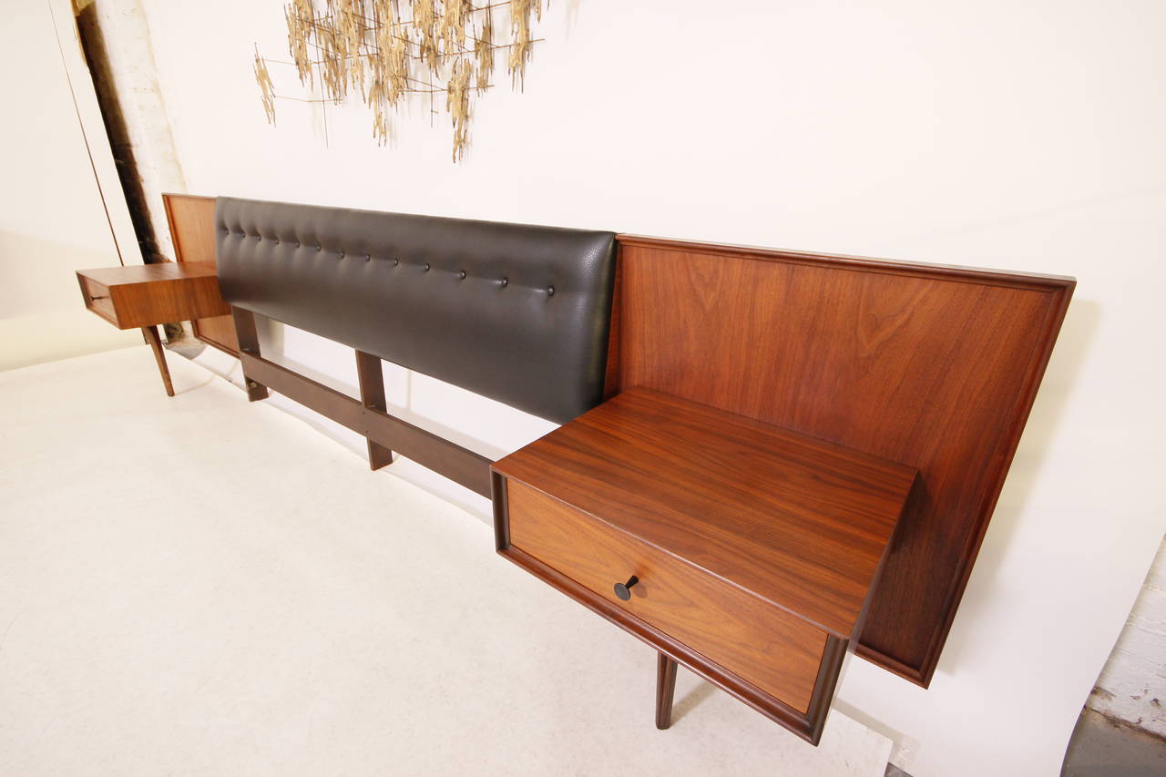 Stunning king-size headboard with floating nightstands by Robert Baron for Glenn of California, newly refinished and upholstered with black leather, circa 1950s. Headboard 126