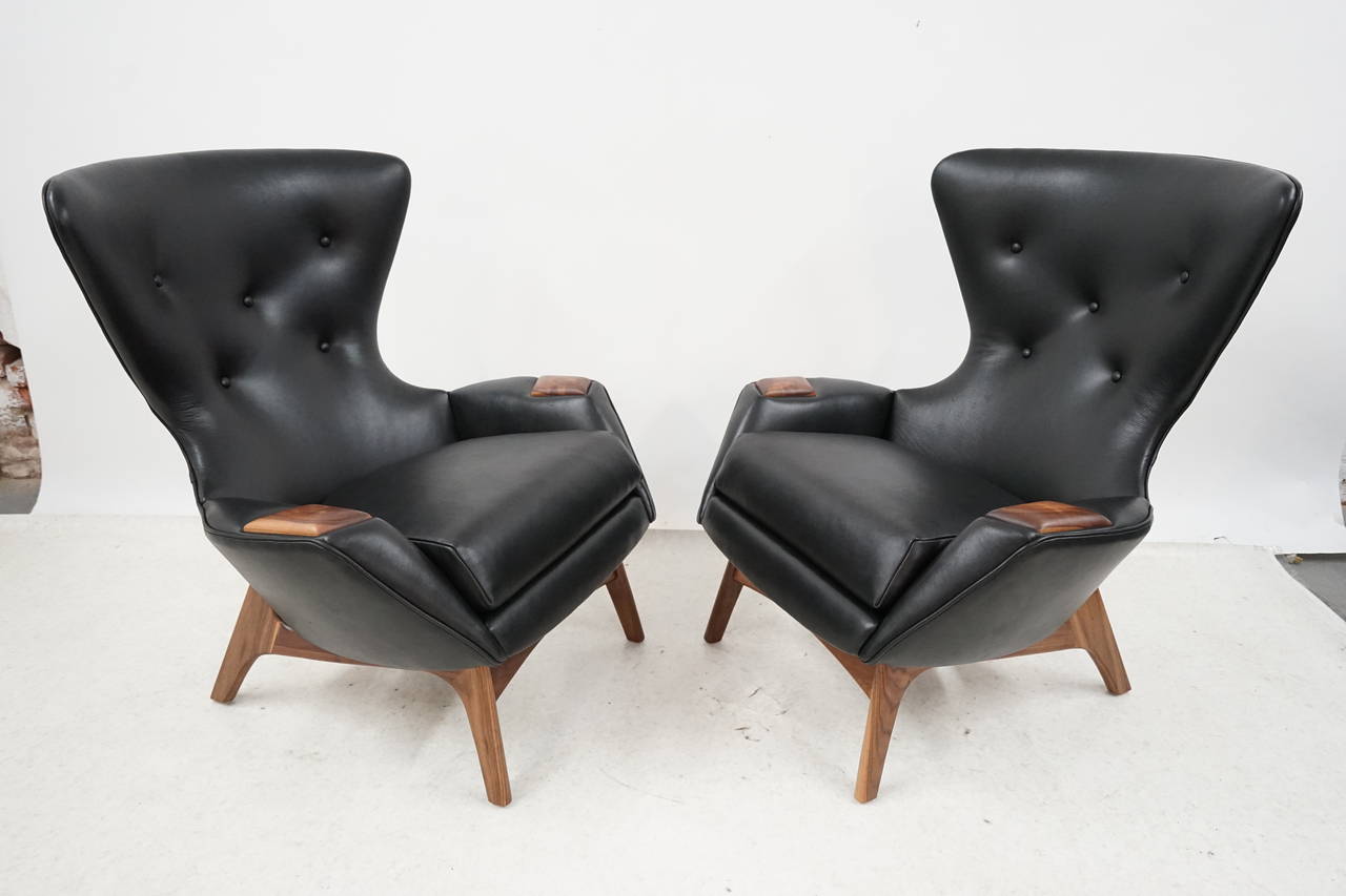 Extremely rare pair of Adrian Pearsall wingback lounge chairs with soft black leather upholstery and gorgeous walnut detail.