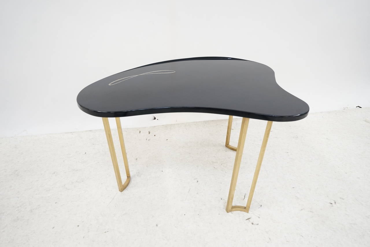 Very well-made table with brass legs and thick lacquer finish with Abalone shell inlay.