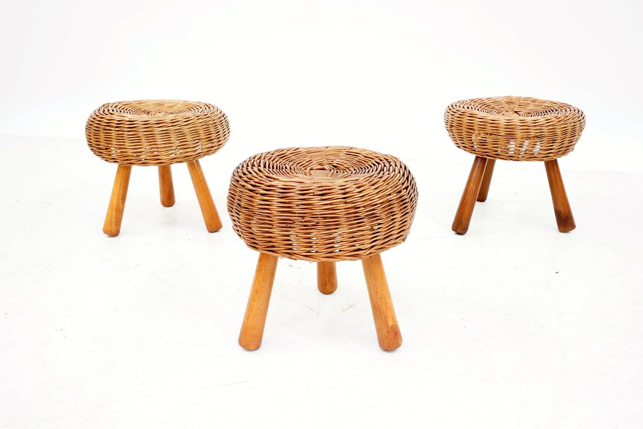 A gorgeous set of three rattan and beechwood stools designed by Tony Paul.