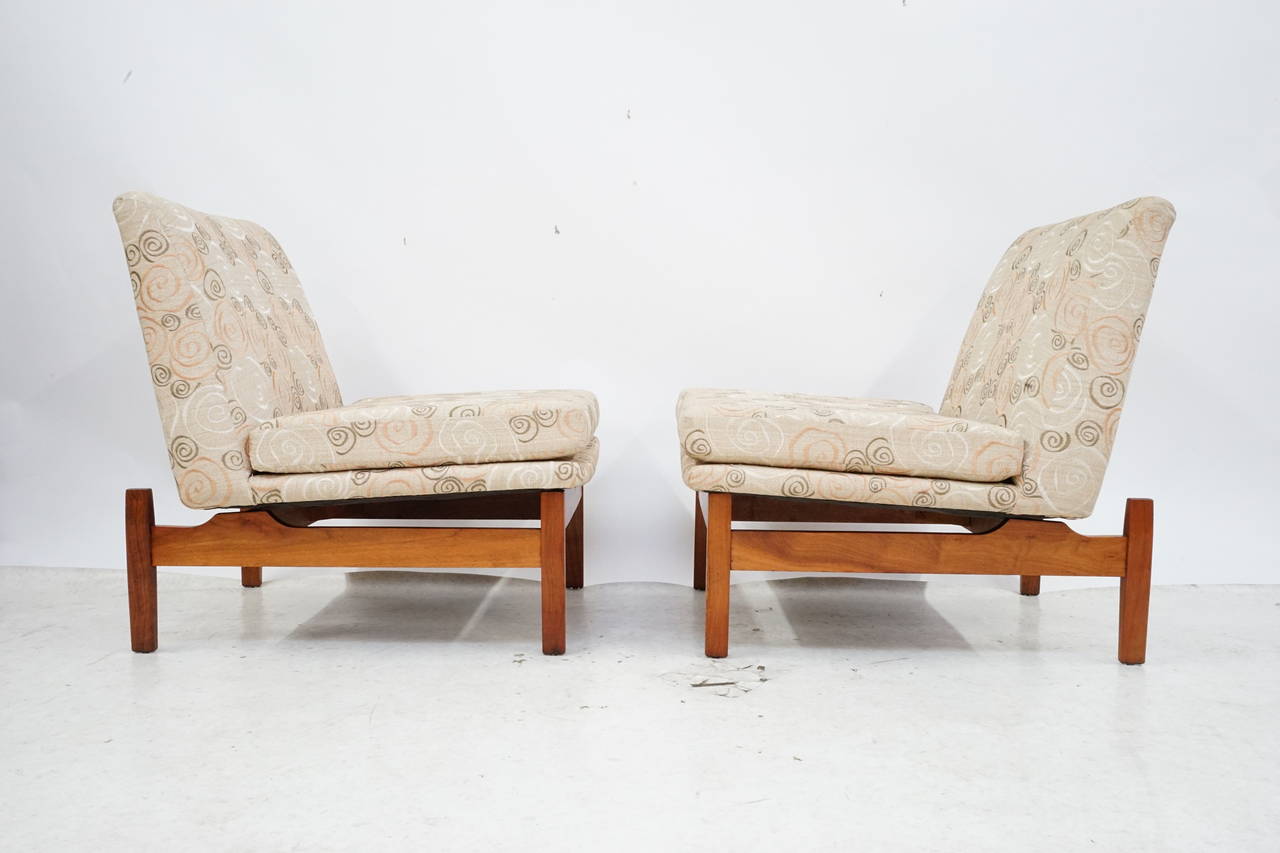 Gorgeous pair of floating slipper chairs with sculpted walnut bases by Jens Risom in excellent condition, circa 1960s.