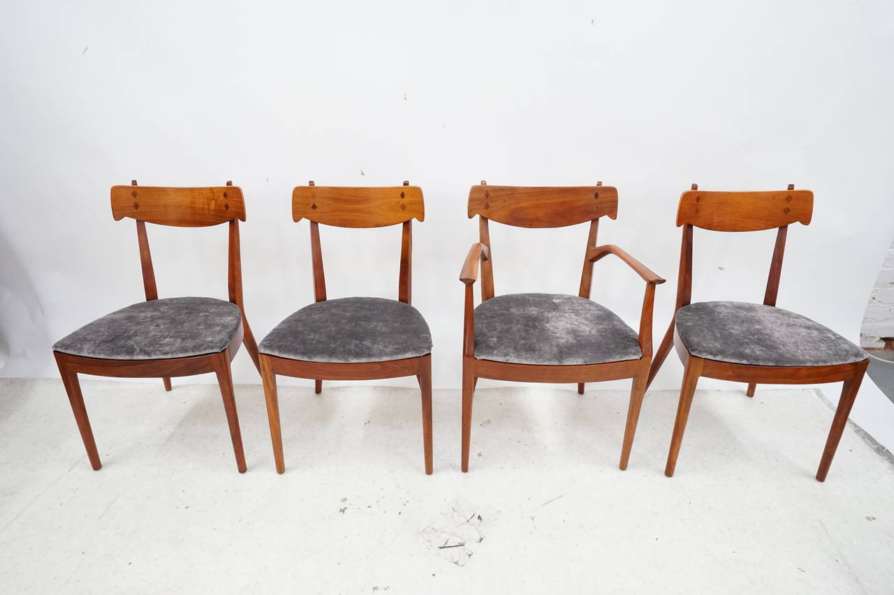 These stunning dining chairs are finely sculpted of walnut with rosewood inlay. Designed by Kipp Stewart and Stuart MacDougall for Drexel, circa 1950, they are sturdy, comfortable and seats are upholstered in a gorgeous grey velvet.