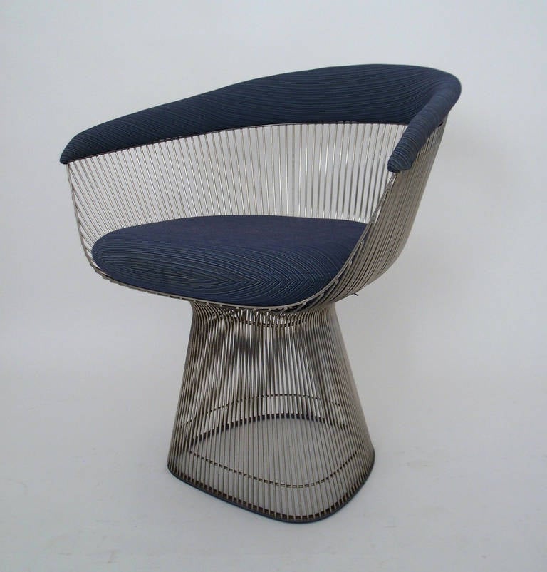 A magnificent set of 8 iconic dining chairs, by Warren Platner featuring original upholstery. First designed in 1966 the chairs are created by welding hundreds of curved, nickel-plated steel rods to circular frames, simultaneously serving as