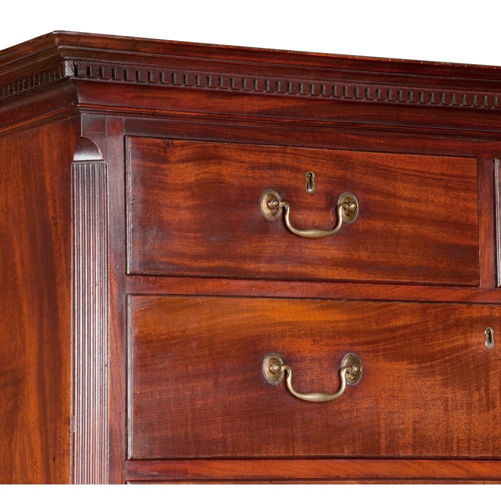 Chippendale solid mahogany chest on chest with dentil crown molding, fluted 
chamfered corners and bracket feet. This magnificent period chest features
all the original antique brass pulls and is in pristine condition considering the
age...Circa
