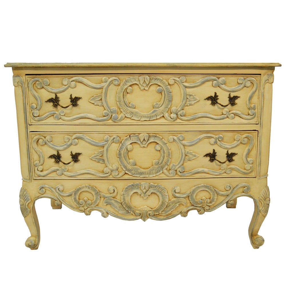 Pair of painted and glazed French provencial commodes with three drawers and original antique brass drawer pulls. The muted shades of color as well as the antiqued glazed finish amplifies the time worn appearance on these chests. Cabriole legs and