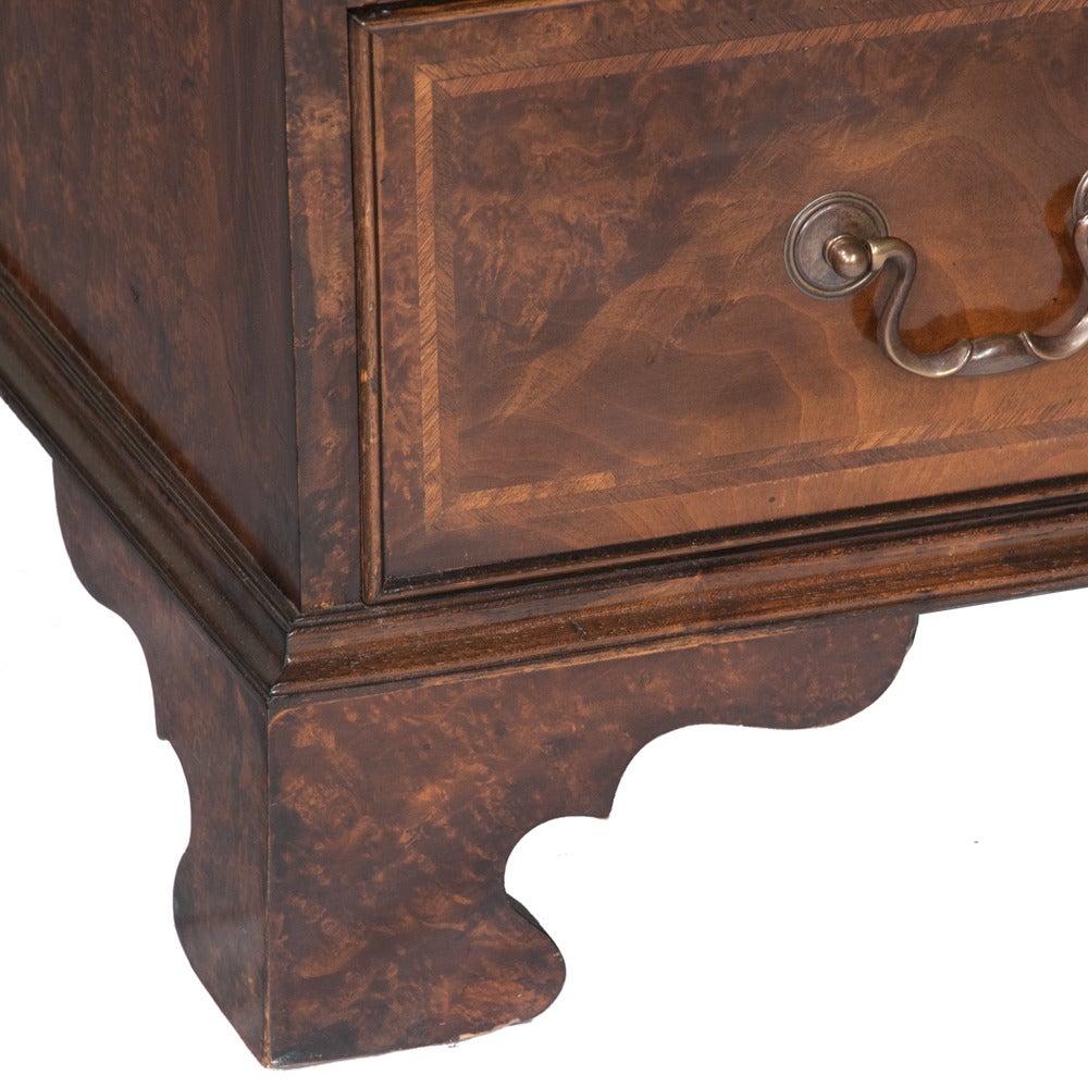 Georgian style burl walnut bureau bookcase with mullion glass doors, urn inlaid slope, good fitted interior on bracket feet. This secretary has three long drawers for storage beneath a desktop that is totally equipped for office or personal usage.