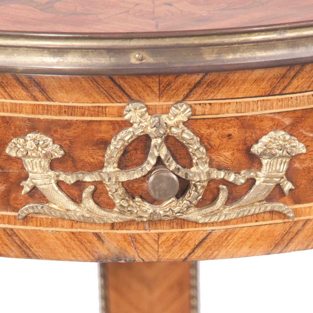Pair of bronze mounted walnut Empire style pedestals with marquetry inlaid tops and on square tapered legs. Pedestals feature intricate carvings as well as original antique brass onlays.