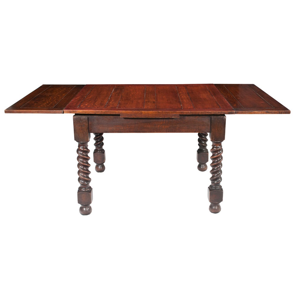 Jacobean oak draw leaf table on barley twist legs, sitting on bun feet, circa 1900 table is in very good condition. Table is longer when leaves are fully extended.