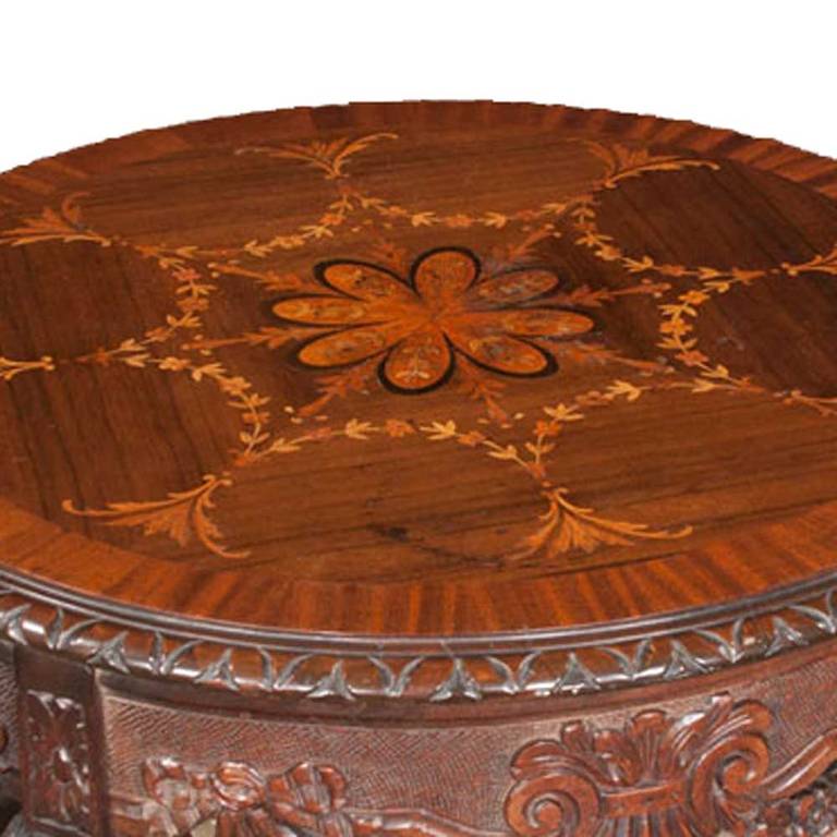 Antique French foyer table with marquetry inlaid top, carved apron, and four cabriole legs with shaped stretcher.