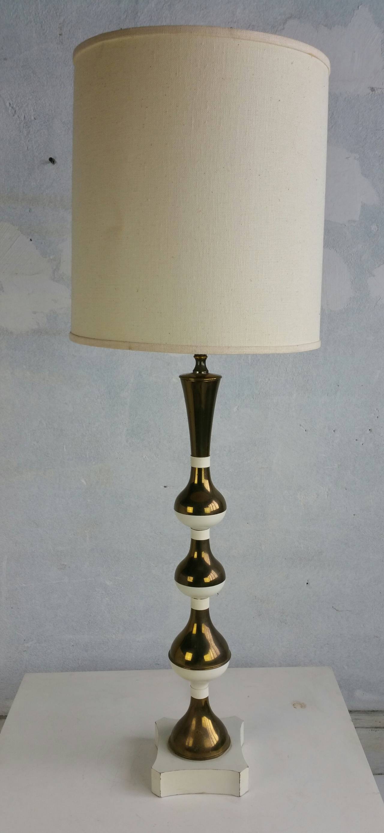 Tall Mid Century Modern Table Lamp. Strong presence. Very dramatic. Manner of Tommi Parzinger. Nice quality. Brass and White Lacquer.