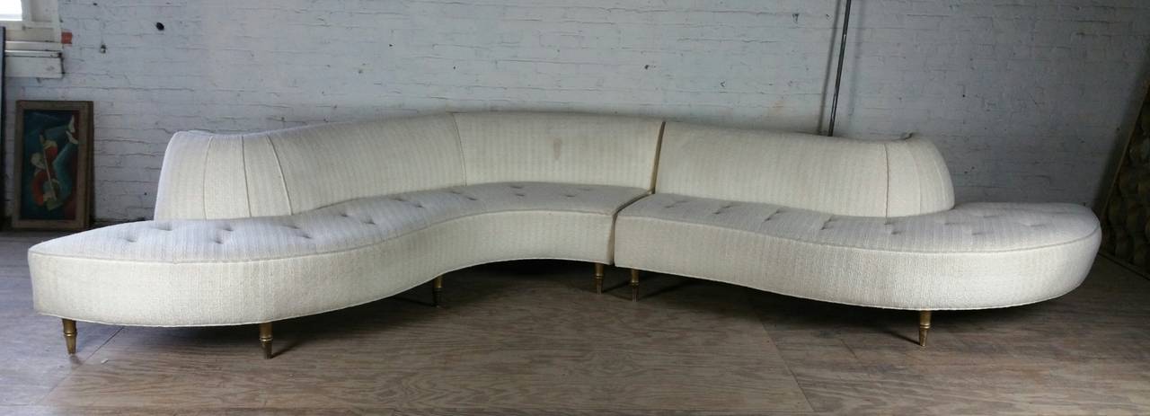 Amazing Mid-Century Modern two-piece serpentine sofa with its undulating lines, this exciting stylized sofa will make an incredible statement. Superior quality, in the manner of Vladimir Kagan, The two sofa's together measure 165