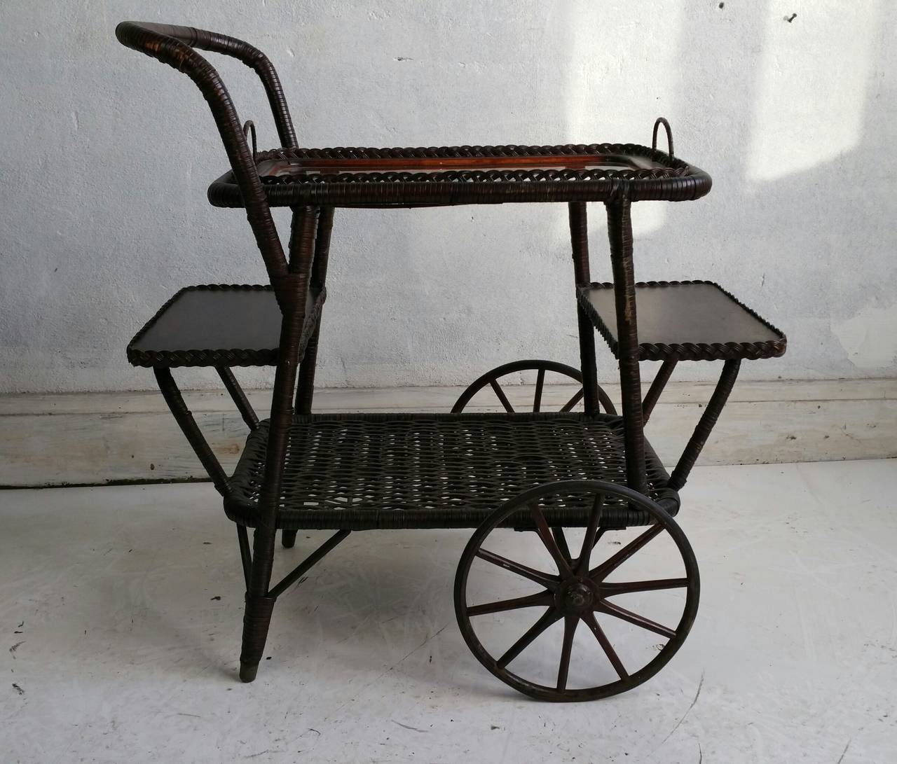 Turn of the Century Wicker Tea Trolly/ Bar Cart... Nice quality and construction..Removable wicker and glass serving tray,, Iron wheels,,