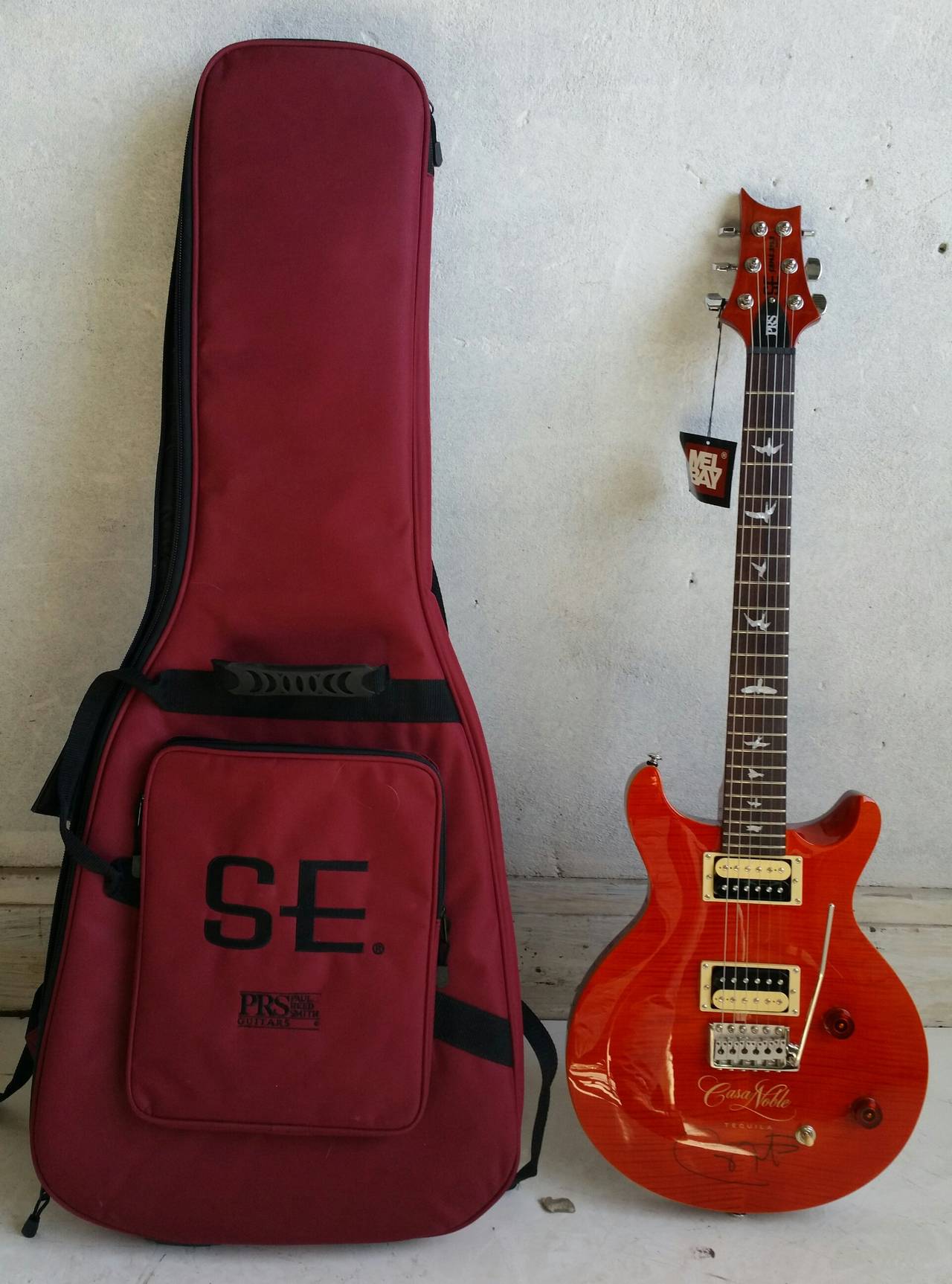 PRS electric guitar, Paul Reed Smith. Orange finish throughout the top, body and neck. The Santana MD features a 