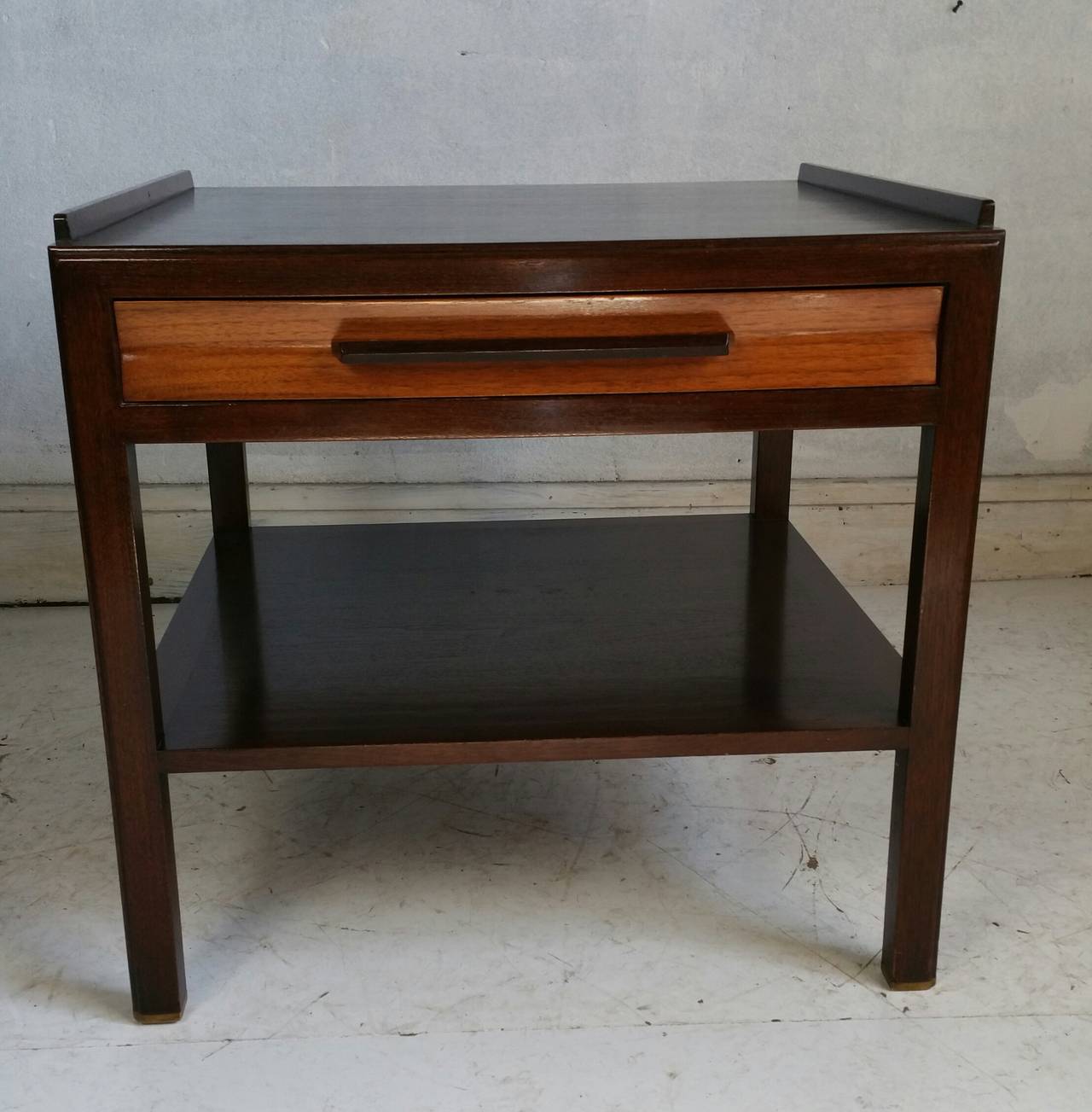 Very unusual lamp or center table designed by Edward Wormley for Dunbar,,Superior quality, Solid mahogany ,, Two-tone finish...,bevel drawer and hand pull.Elegant brass trim to bottom legs. Simple .sleek architectural design,,