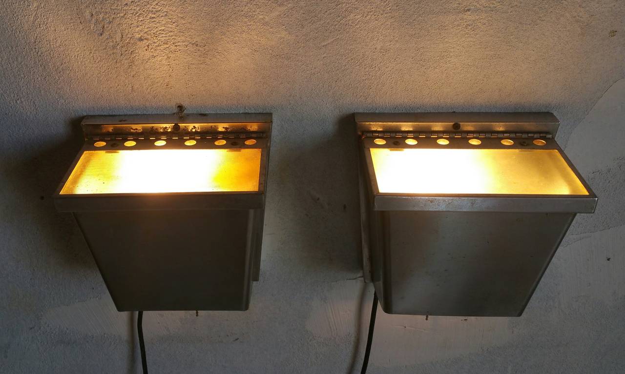 Very unusual wall sconces,,Architectural,minimal design.. 2-way light option which can be used as up light,down light, separatly or in unison.Superior quality,, Stainless steel construction,For interior or exterior.