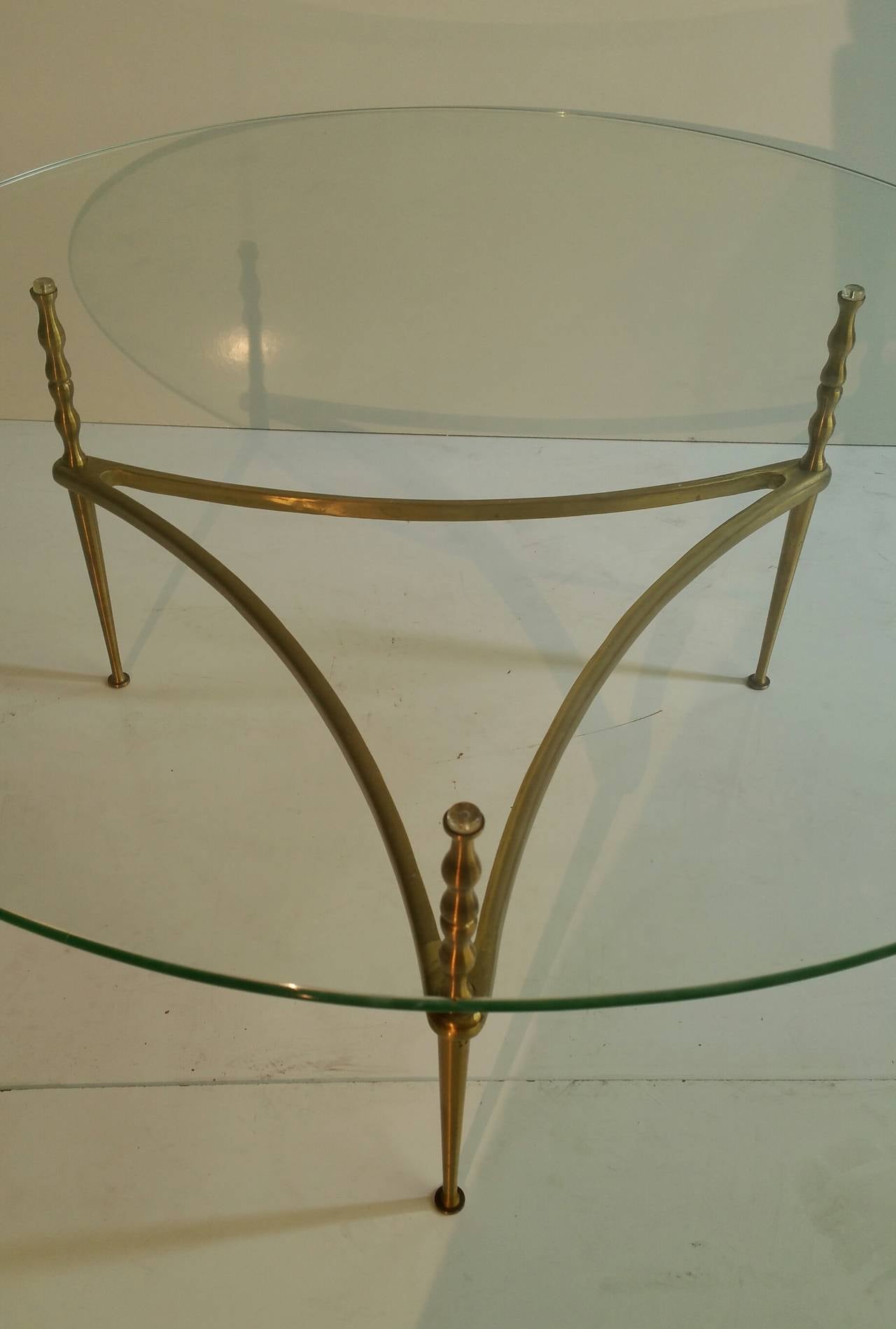 Elegant cocktail table, superior quality and construction. Brass and glass. Made in Italy.
