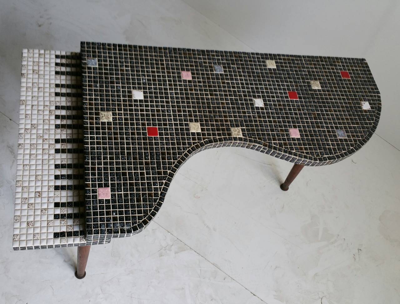 Mid Century Modern Cocktail or Occasional Table. Cleverly crafted and fully covered in mosaic tile in the shape of two level baby grand piano. Definitely handmade. Makes a fun, whimsical statement