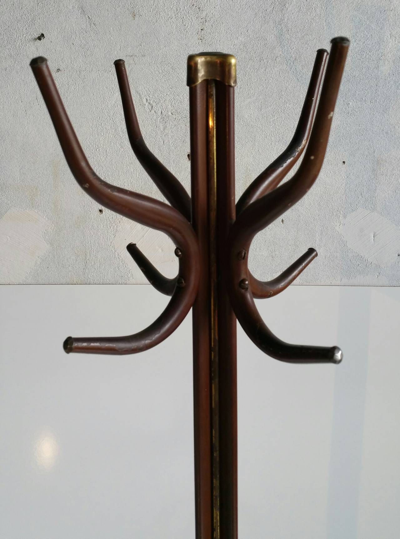 Unusual steel and mixed metal coat stand, Industrial, yet sleek and elegant. Amazing detailing, brass hammered top finial as well as brass striping applied to standard. Beautiful detailed silvered faceted ends to end hooks, also designed steel