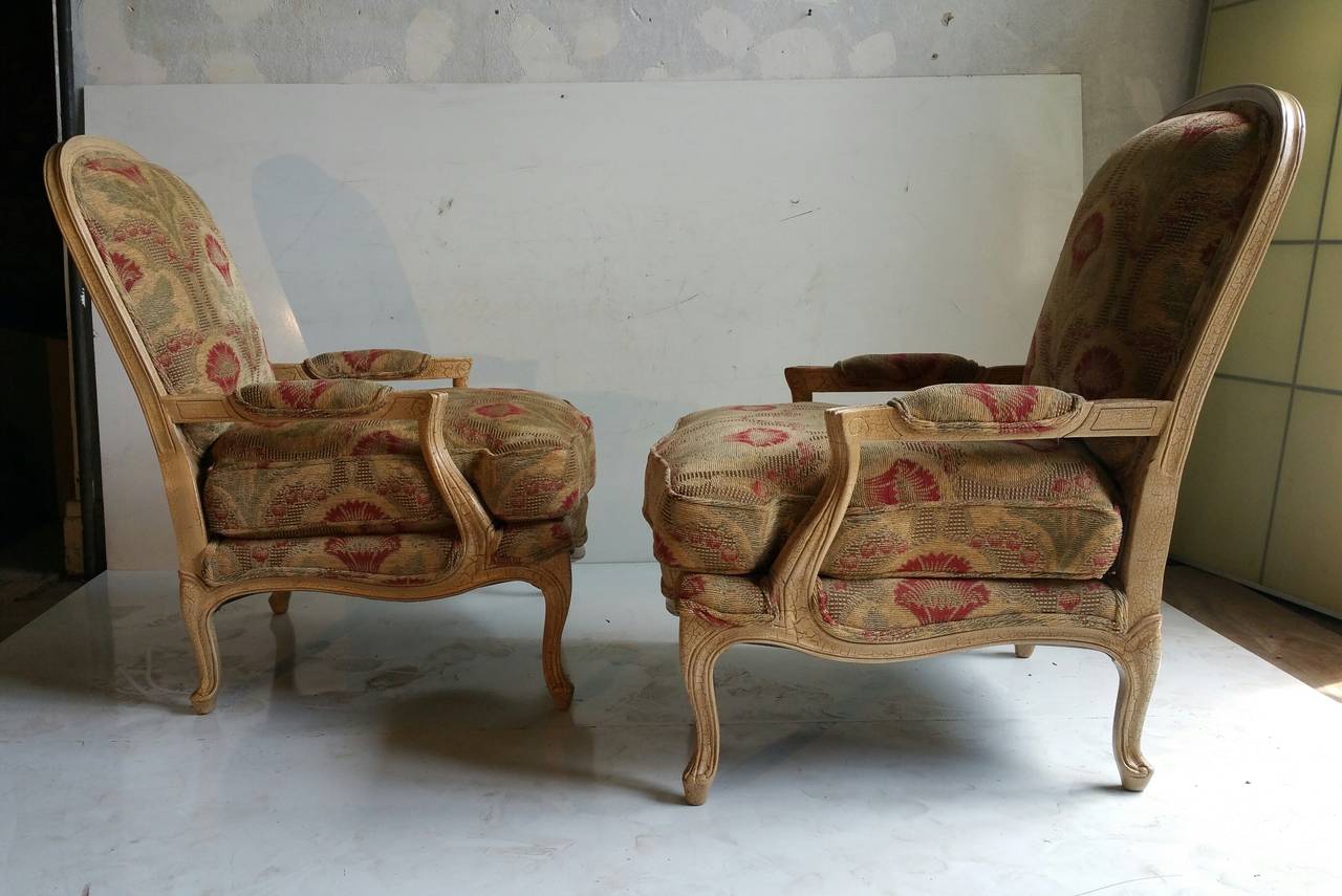 Stunning pair of French Lounge Chairs, Crackle distressed warm off white finish, recently reupholstered, in a dramatic fabric