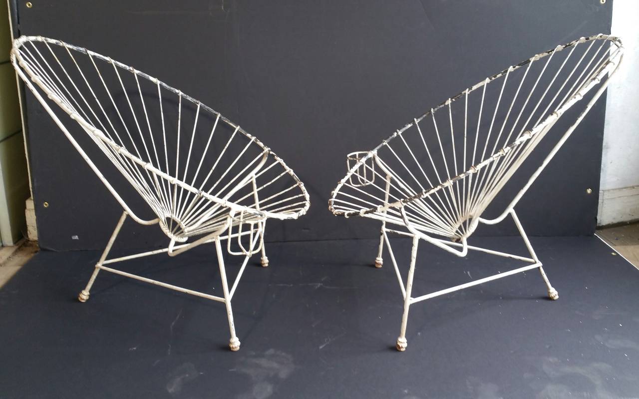 Stunning pair of wire iron garden chairs, amazing architectural design, oval clamshell, whimsical cup holders possibly French. Original paint beautiful surface color.