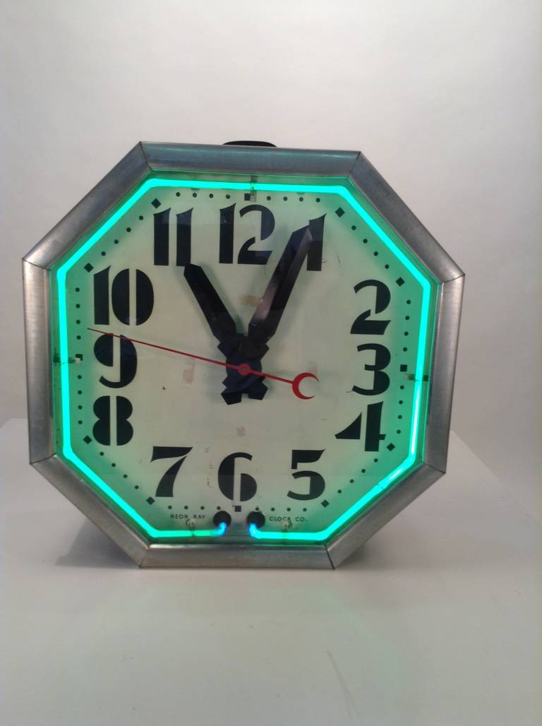 Exceptional example of clean sleek modernist deco design. Green neon, white face stylized numbers keeps perfect time.