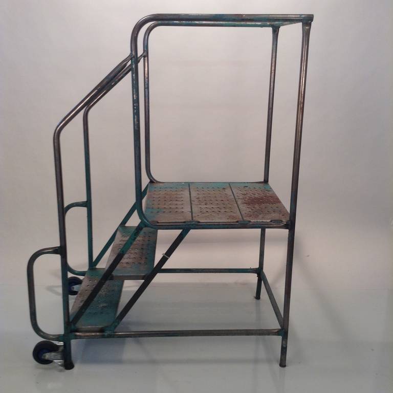 Very architectural. Wonderful blue and green patina, rolling platform step ladder, early 20th century. Graduating steps, 7.5