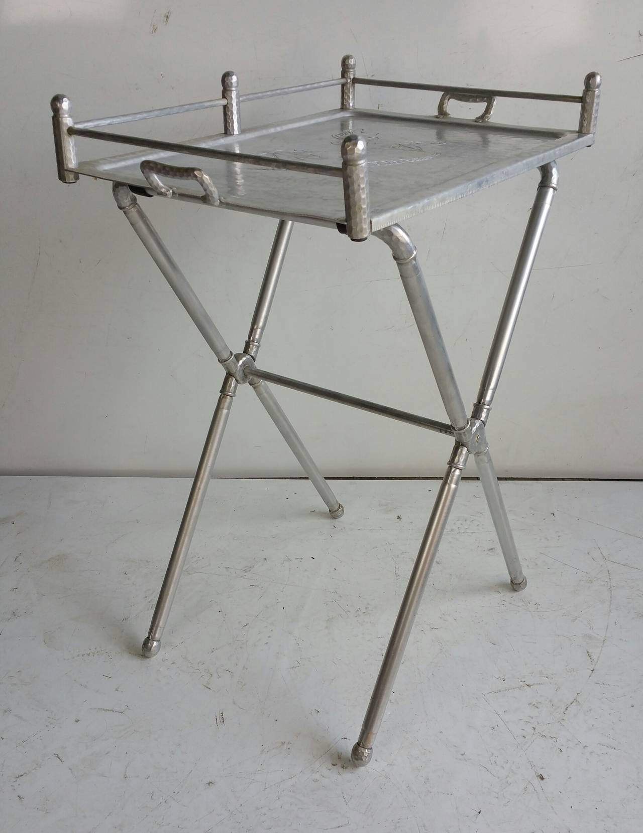 Hand wrought Signed Everlast co ,Polished Aluminum Bar Tray folding table,with acorn leaf engraving circa 1940,,Sleek ,simple .elegant design.

Measurements to tray height 30